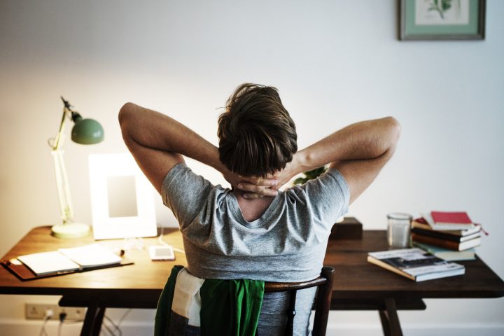 Man stressed while working on laptop
